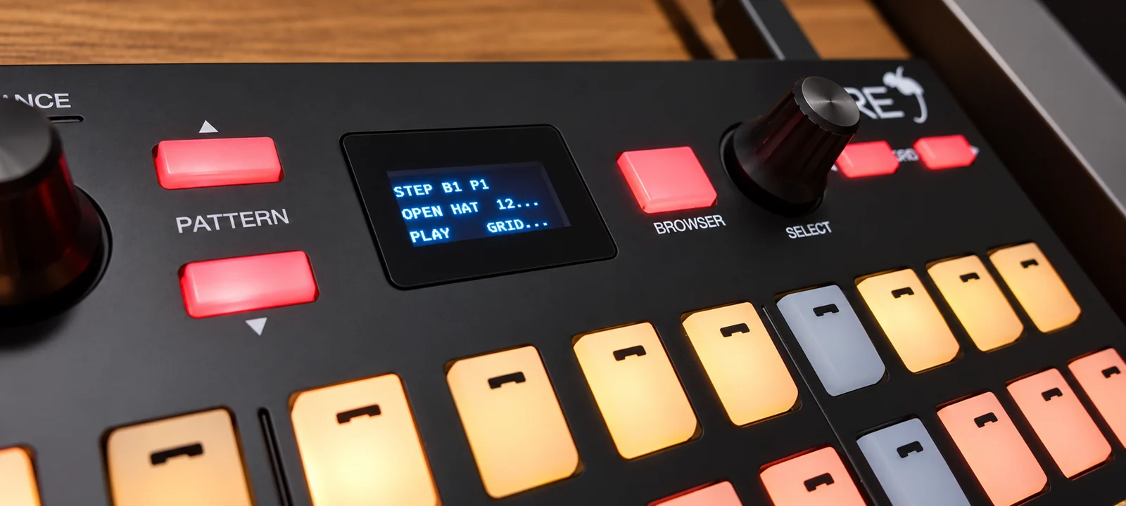 Detalhe do Akai Fire com pads iluminados e tela exibindo o pattern